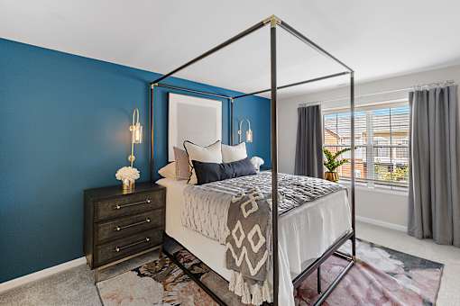 A bedroom with a four poster bed and a dresser at Briarcliff Village, Michigan, 48390