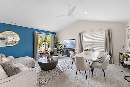 A living room with a blue wall and a television at Briarcliff Village, Michigan, 48390