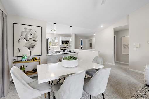 A dining room with a white table and chairs at Briarcliff Village, Michigan, 48390