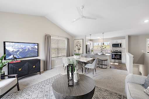 A living room with a television, a dining table, and chairs at Briarcliff Village, Michigan, 48390