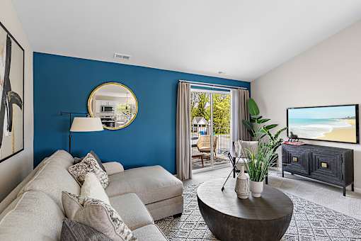 A living room with a grey couch and a round coffee table at Briarcliff Village, Michigan, 48390