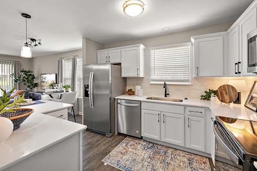 A modern kitchen with white cabinets and stainless steel appliances at Briarcliff Village, Michigan, 48390