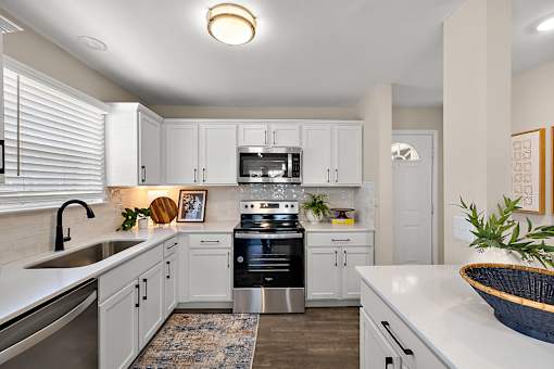 A modern kitchen with white cabinets and stainless steel appliances at Briarcliff Village, Michigan, 48390