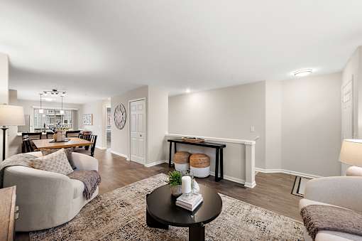 A living room with a grey couch, a coffee table, and a fireplace.