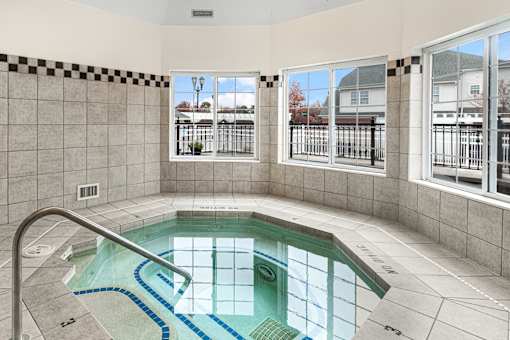 A small indoor pool with a metal railing.