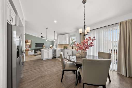 A modern kitchen with a dining table set for four.