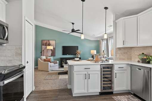 A kitchen with a stove top oven and a refrigerator.