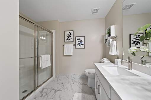 A bathroom with a marble floor and a white sink.