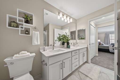 A bathroom with a white toilet, sink, and mirror.