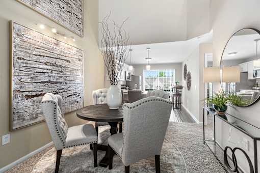 A dining room with a wooden table and chairs.