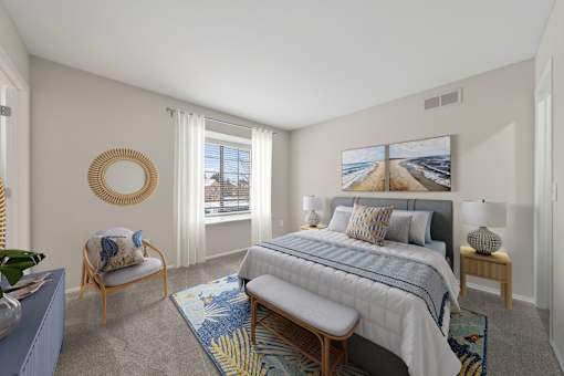 A bedroom with a large bed and a view of the beach.