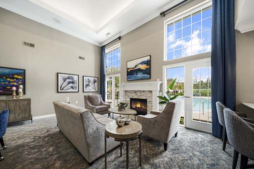 A living room with a fireplace and a painting on the wall.