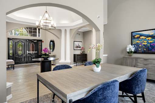 A dining room with a wooden table and blue chairs.