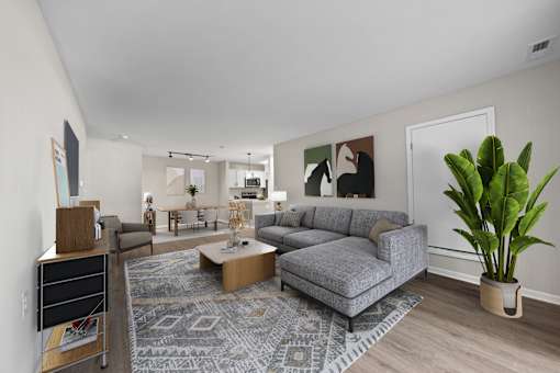 A living room with a grey couch and a coffee table.