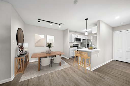 A modern kitchen with a dining table and chairs.