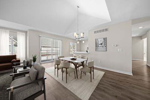 A modern dining room with a glass table and chairs.