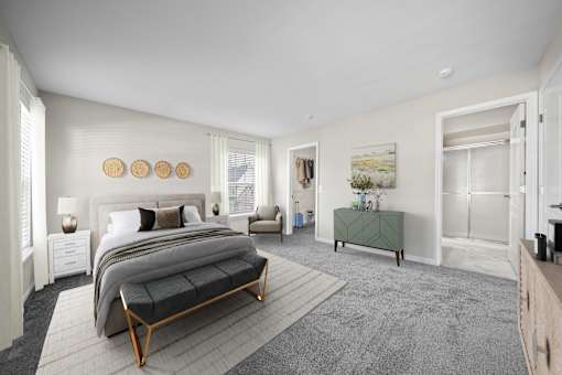 A bedroom with a large bed and a green bench.