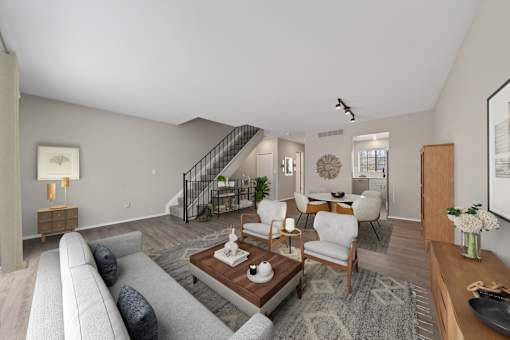 A living room with a grey couch and a wooden coffee table.