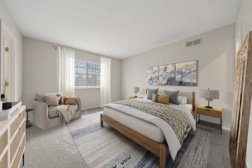 A bedroom with a large bed and a painting on the wall.