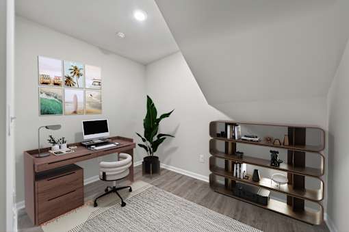 A home office with a desk, chair, and a plant.