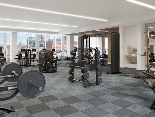 A gym with a variety of equipment including weights and machines.