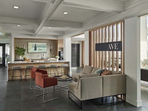 A modern living room with a bar area and a sofa.