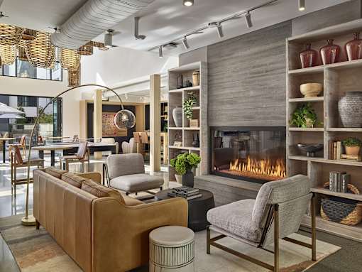A modern living room with a fireplace and a sofa.