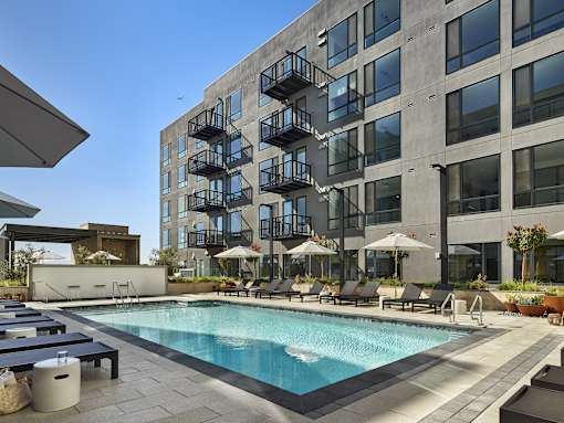 A large building with a pool in front of it.