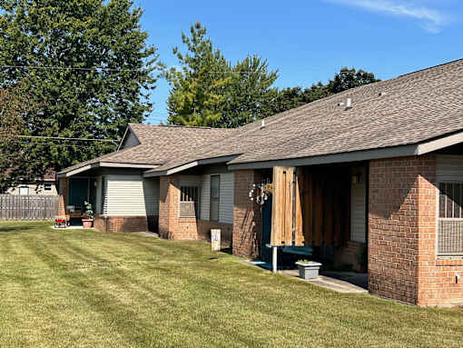 a new roof on a brick house with a yard