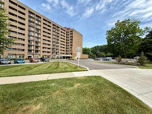 A large apartment complex with a green lawn in front.