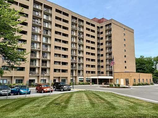 A large apartment building with a flag on the front.