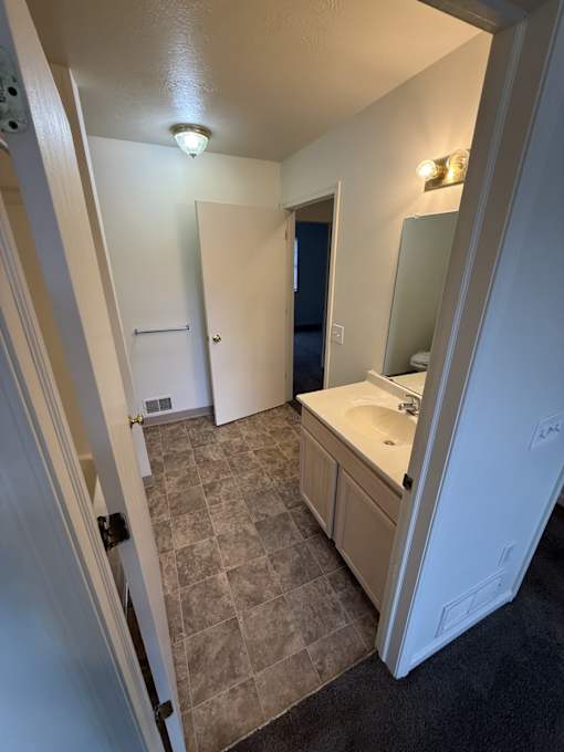 A bathroom with a sink and a mirror.