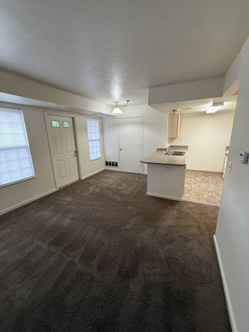 A room with carpeted floor and white walls.