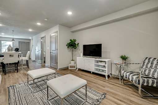 an open living room and dining room with a tv and a table and chairs