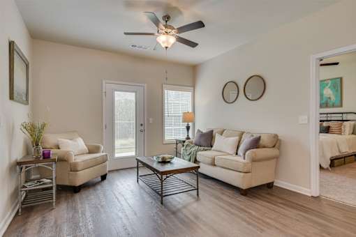 a living room with a ceiling fan and two couches at The Vista Apartments & Townhomes, South Carolina