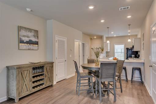 a kitchen and dining room with a table and chairs at The Vista Apartments & Townhomes, Warrenville