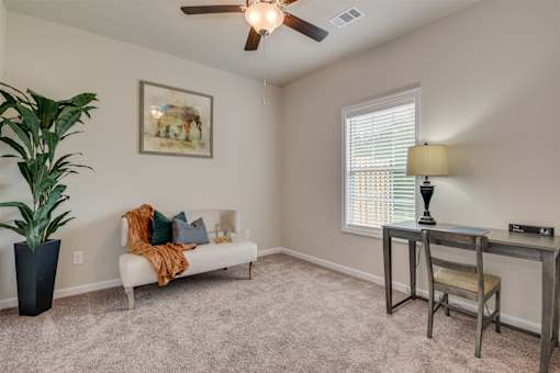 a living room with a couch and a table and a ceiling fan at The Vista Apartments & Townhomes, Warrenville, SC, 29851