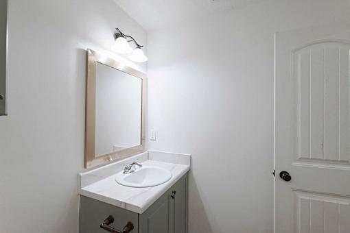 Bathroom with framed mirror and vanity lighting at Sterlington Apartments, Grovetown, GA