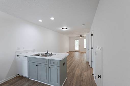Kitchen area and living room with hardwood-style flooring throughout at Sterlington Apartments, Grovetown, GA
