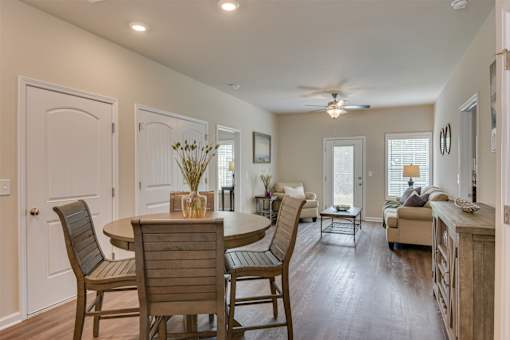 a dining room and living room with a table and chairs at The Vista Apartments & Townhomes, Warrenville, SC