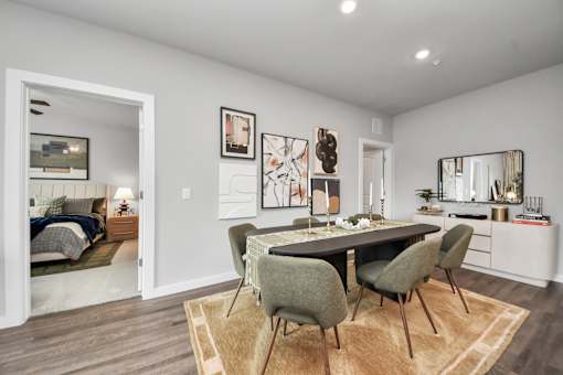 A modern dining room with a table set for four.