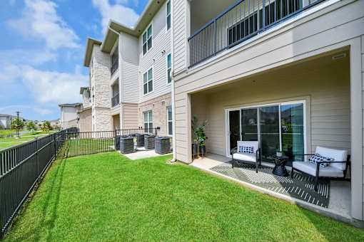 A well-maintained lawn in front of a modern apartment building.