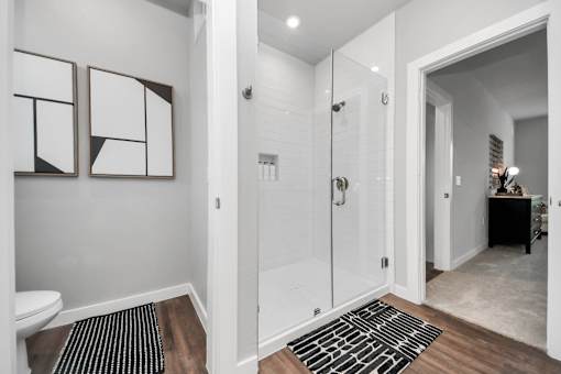 A bathroom with a toilet, a sink, and a shower.