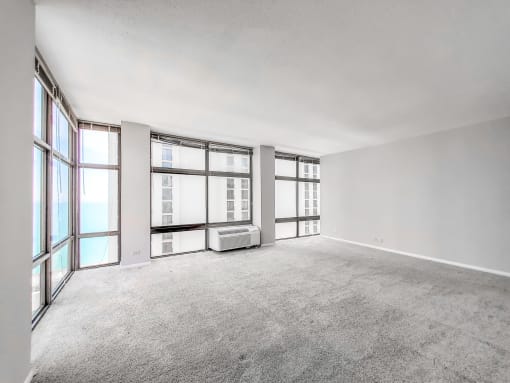 a bedroom with a large window and white walls