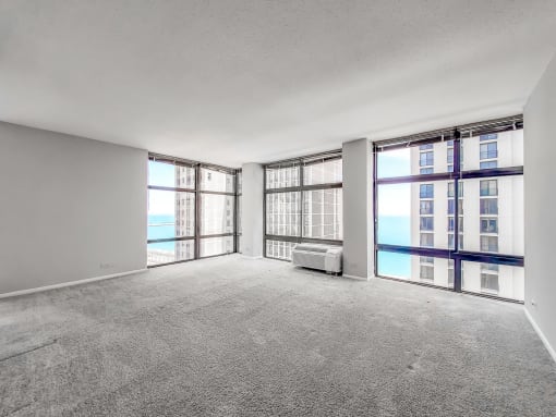 an empty living room with a view of the ocean