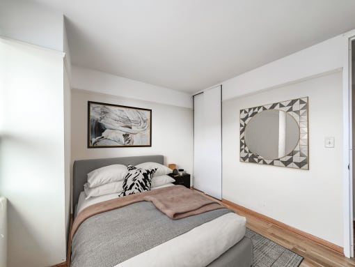 a bedroom with a large bed and a mirror on the wall