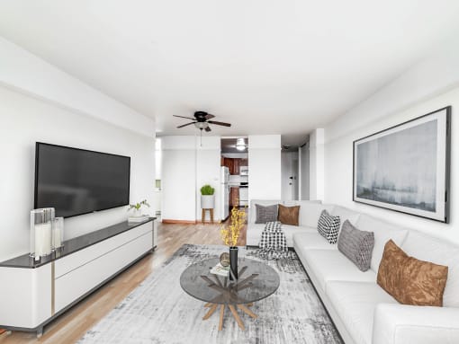 a living room with a white couch and a glass coffee table