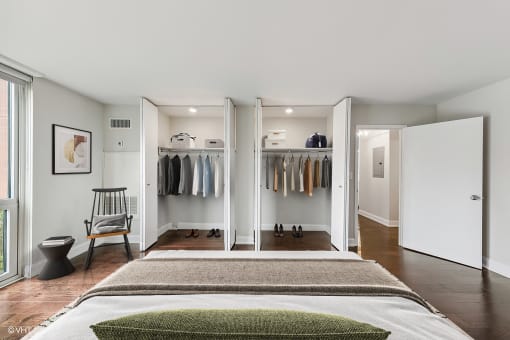 a bedroom with a bed and a closet with closet doors
