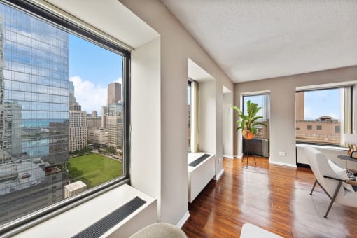 a living room with a large window and a view of the city
