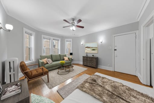 a living room with a couch and a ceiling fan